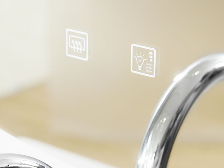 Spiegel close-up bedieningspaneel en stukje chromen kraan